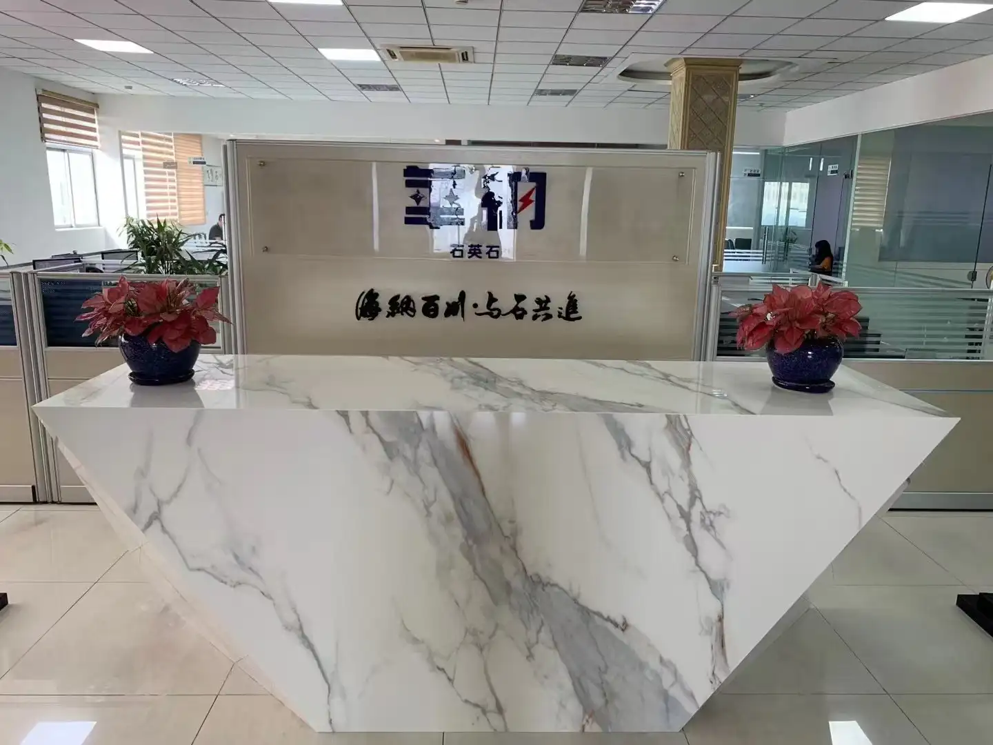 Warner Stone corporate headquarters reception area with custom Calacatta quartz front desk
