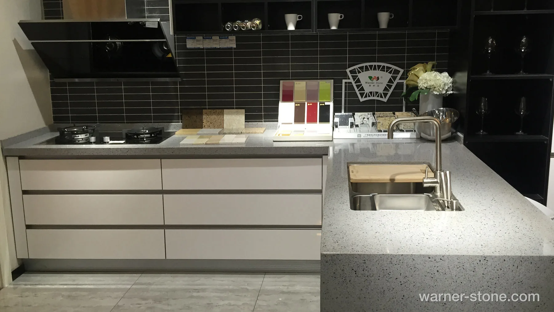 Contemporary Kitchen Showroom Featuring Terrazzo Quartz Island with Undermount Sink