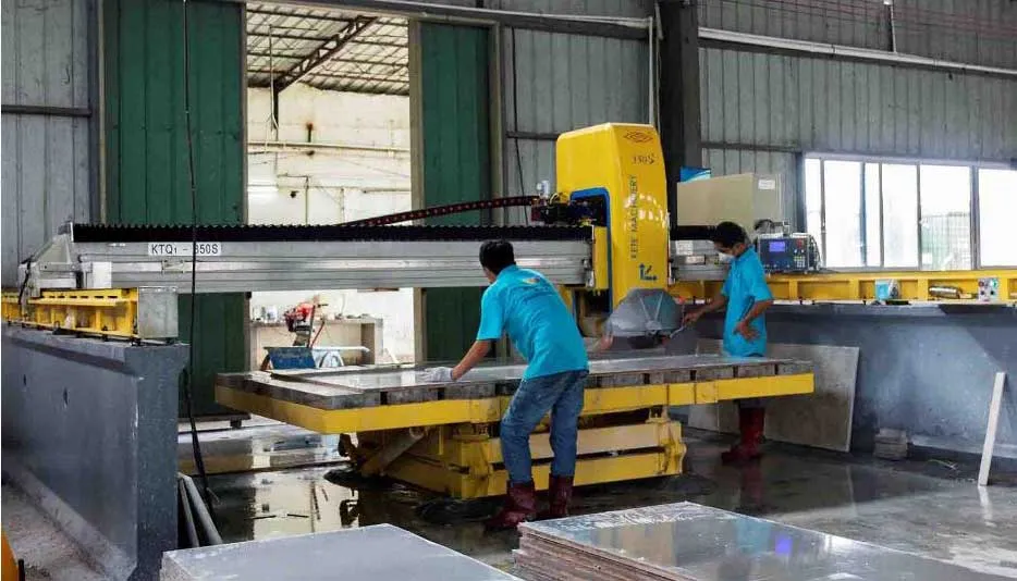 CNC infrared wet bridge saw precisely cutting engineered quartz slabs