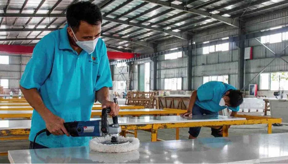 Skilled artisan hand-polishing and beveling custom quartz edges