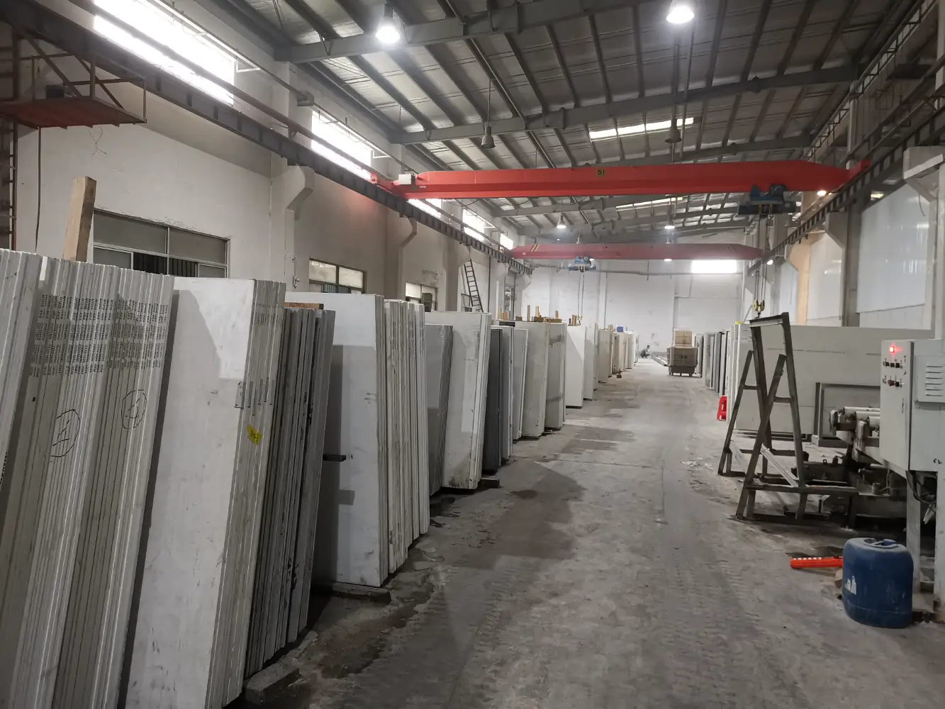 Warner modern quartz slab warehouse with crane lines and extensive inventory