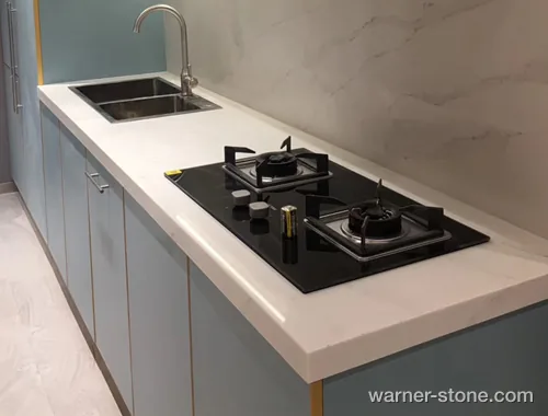 Minimalist kitchen waterfall edge island in pure white engineered quartz