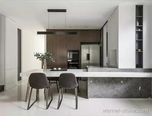 Open-concept dining island combining grey textured quartz with Calacatta