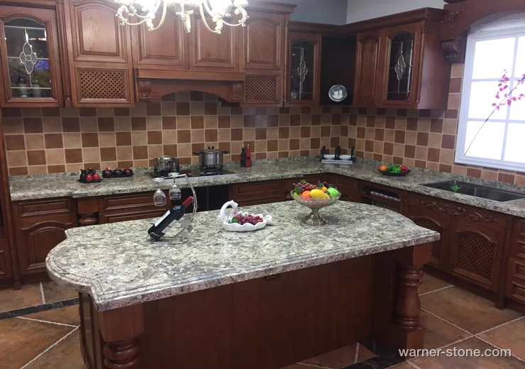 Estate kitchen featuring custom-shaped island topped with Amazon green veined quartz surface and intricate carved columns