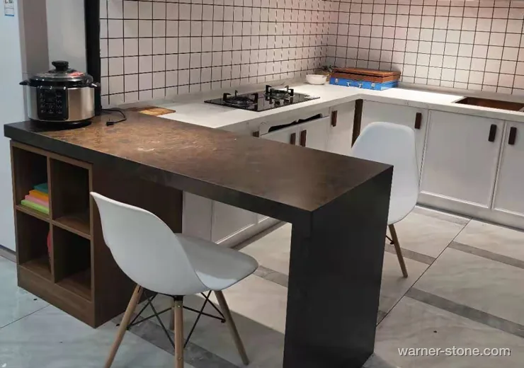 Modern kitchen featuring mitered waterfall breakfast bar in leathered brown quartz