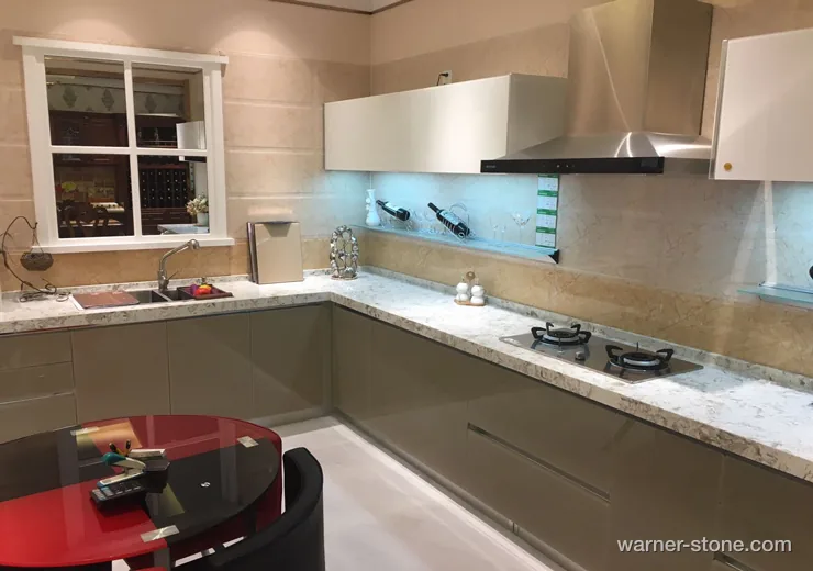 Taupe modern kitchen cabinetry with warm white marble-veined quartz countertop and seamless backsplash